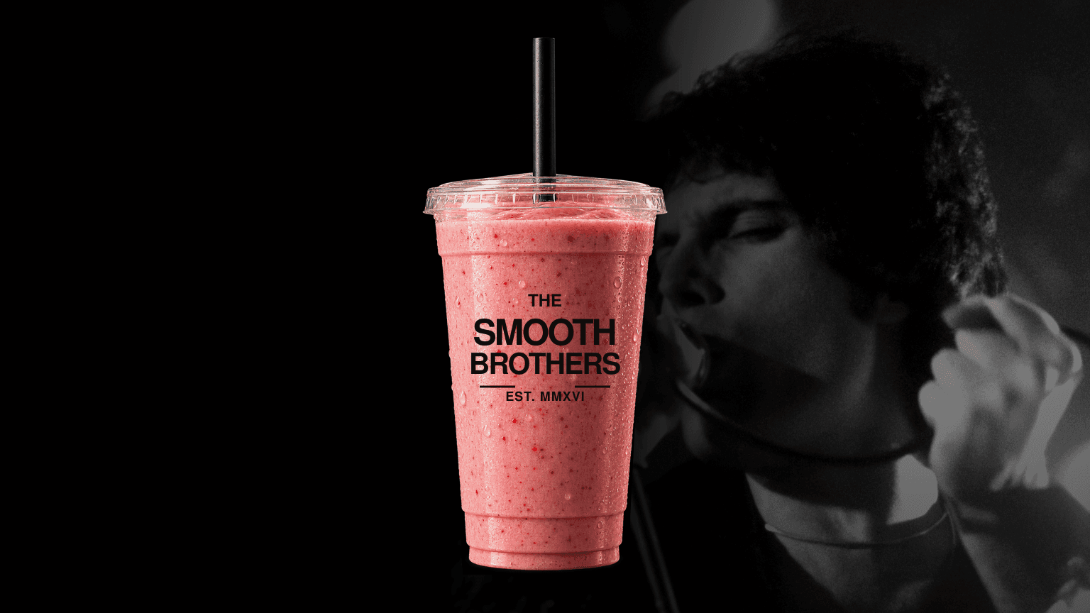 Queen strawberry smoothie in a branded The Smooth Brothers cup beside Freddie Mercury